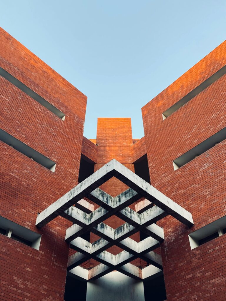 Modern red brick architecture with geometric patterns, captured in New Delhi, India.