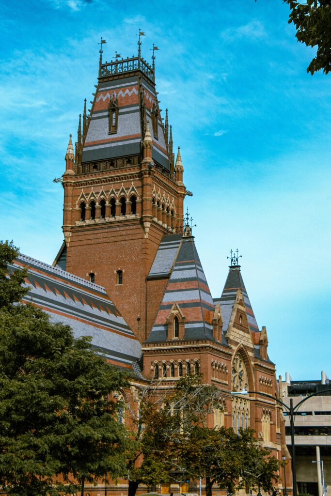 Gothic architecture of Memorial Hall at Harvard with vibrant sky.