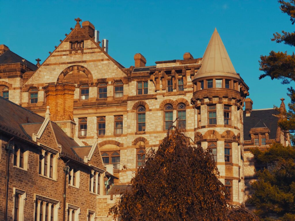 A stunning Victorian Gothic castle facade captured in warm sunset light.
